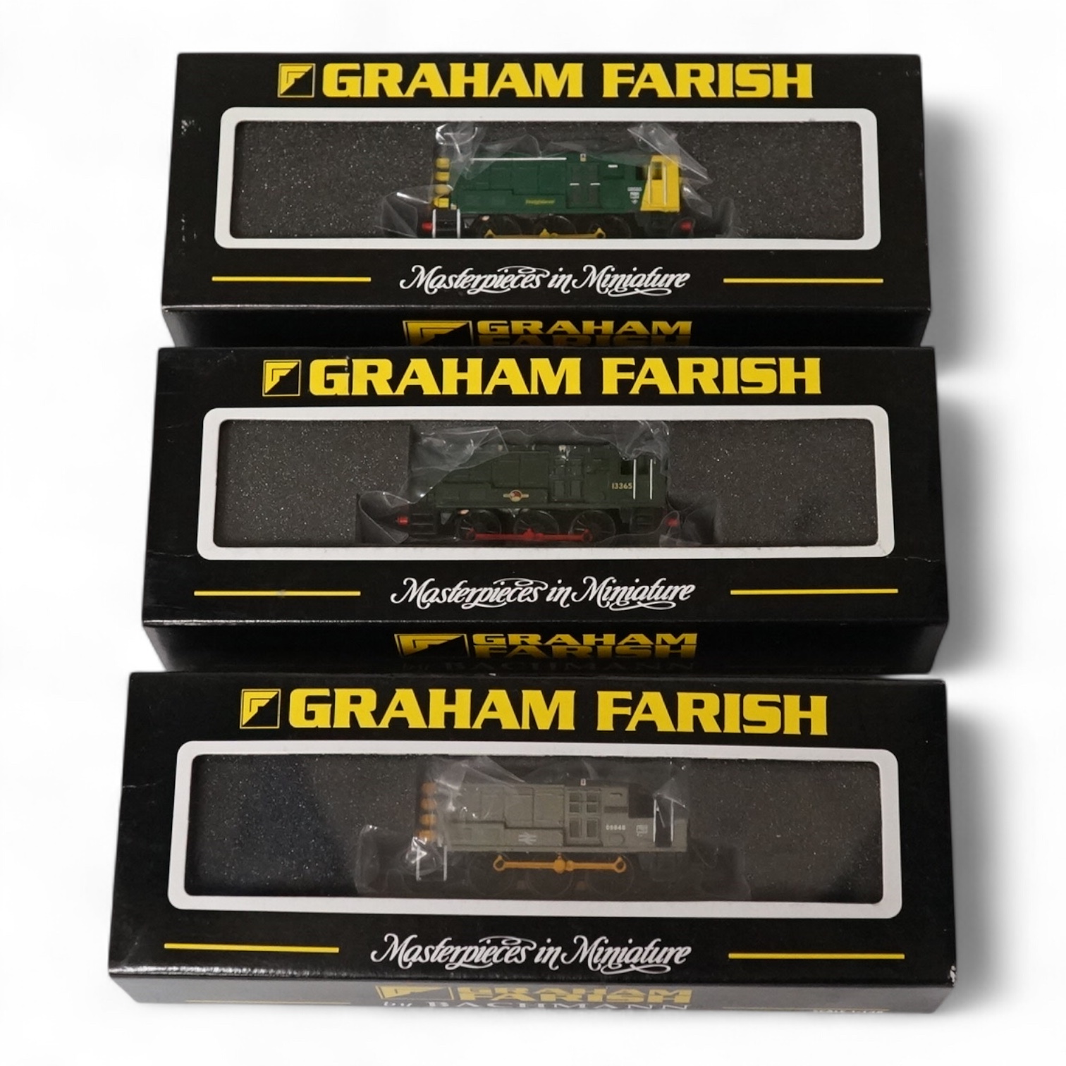 Three boxed Graham Farish N gauge railway Class 08 diesel locomotives; 08585 (371006), 13365 (371003) and 08648 (371007). Condition - fair to good.